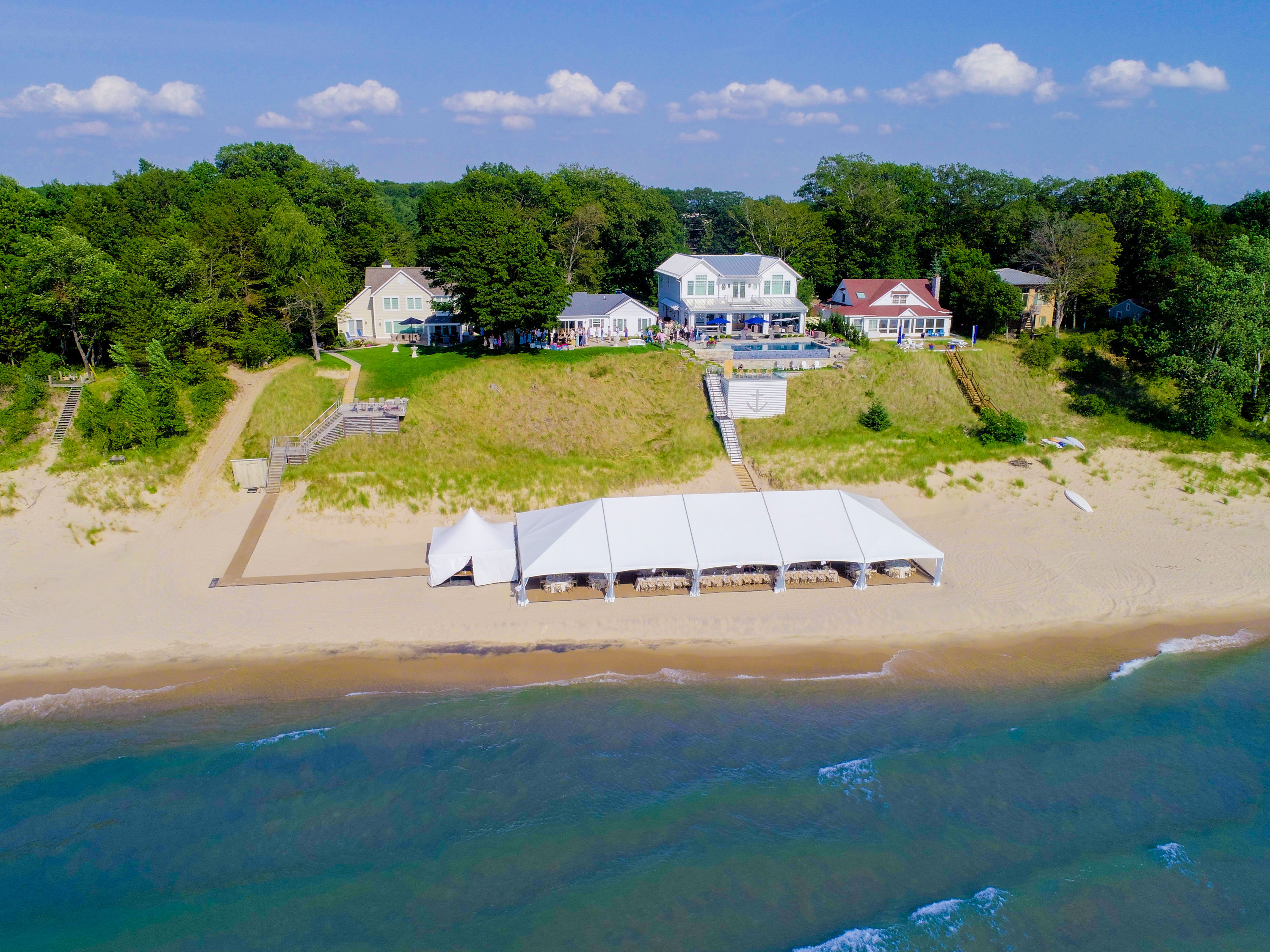Aerial view of large frame tent on beachfront property for event in Michigan